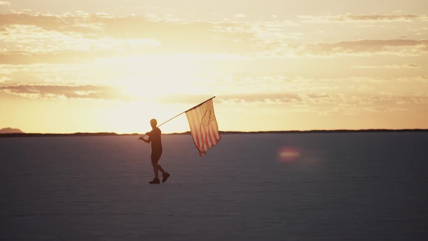 A person is carrying an American flag