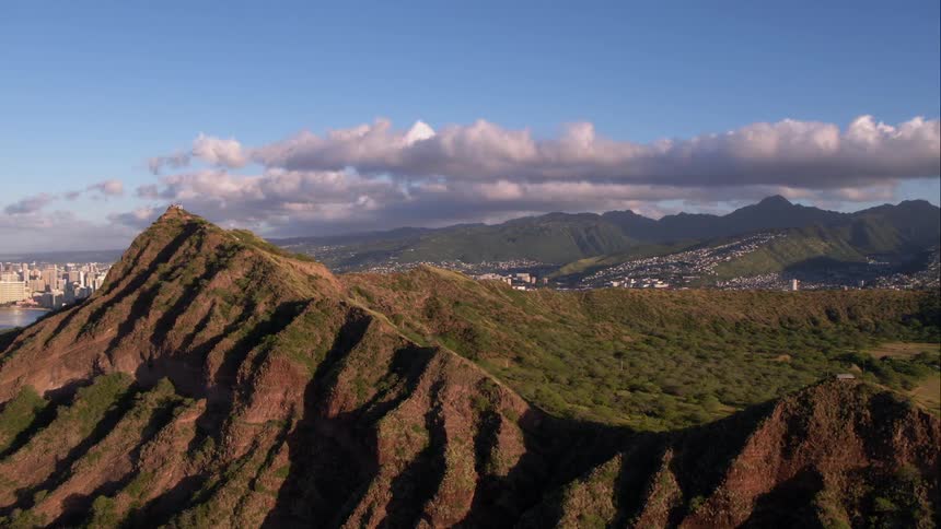 A mountain peak blocks the view of a city