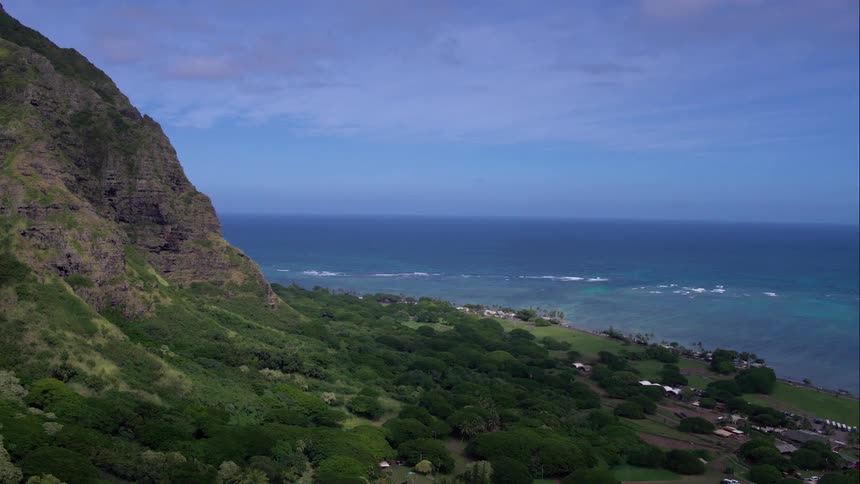 A rocky slope leads down to the ocean shore