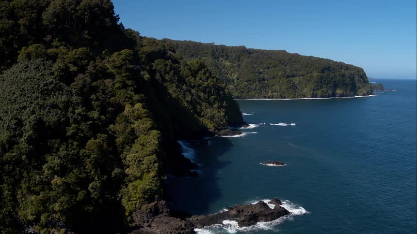 A view overlooking the green mountains next to the ocean