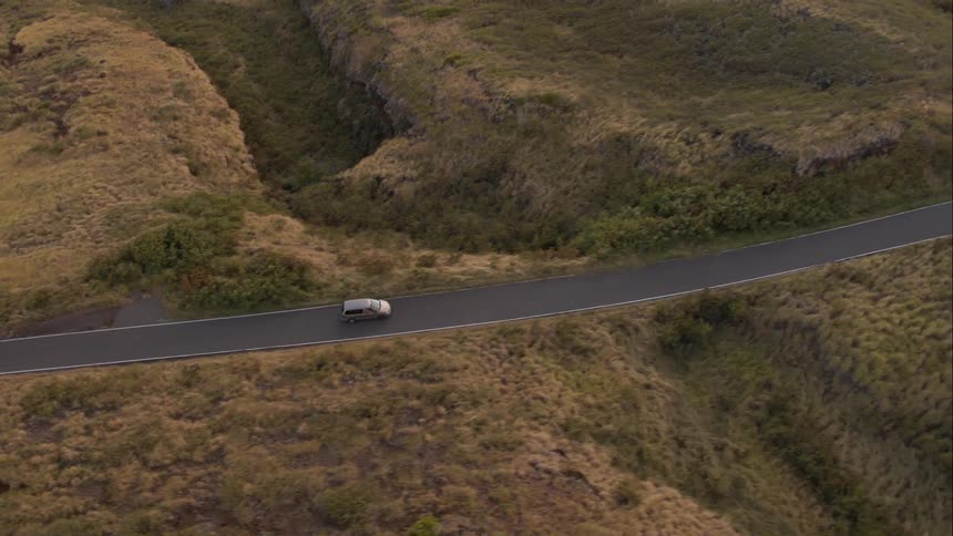 A vehicle driving down a deserted road