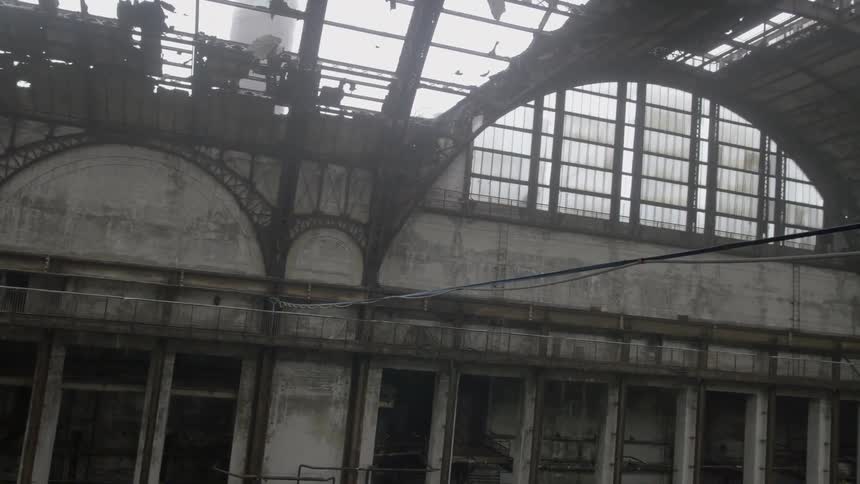 Electrical wires crossing an abandoned and rundown building