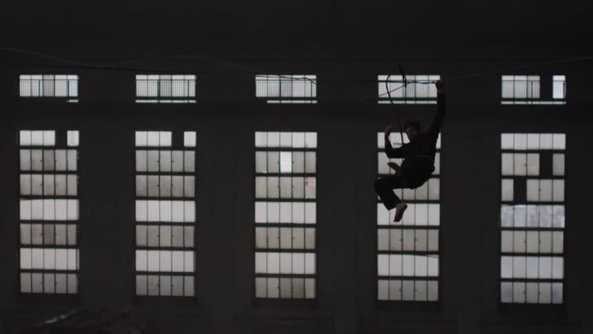 A man is  walking a tightrope
