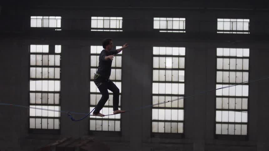 A man walking over a tightrope