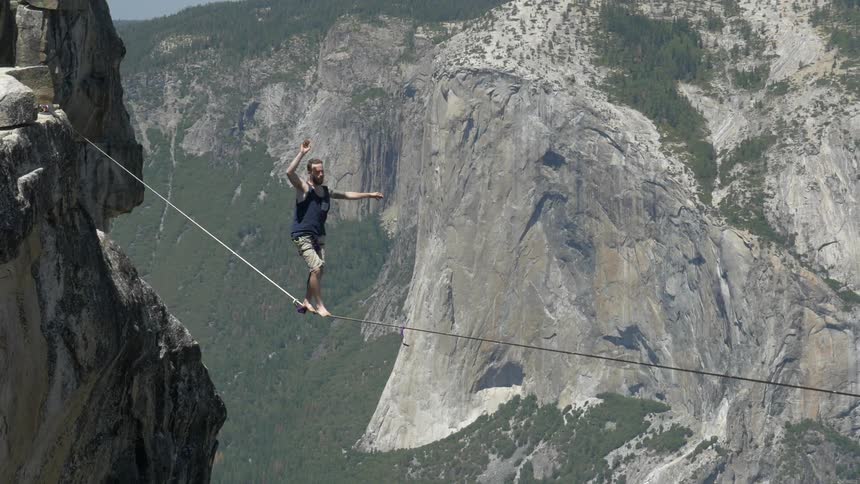 A man is walking a rope