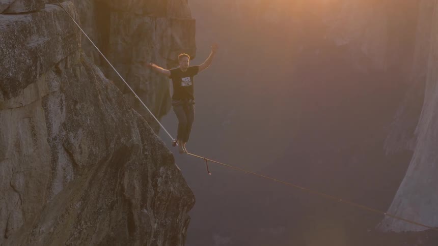 A man is walking a tightrope