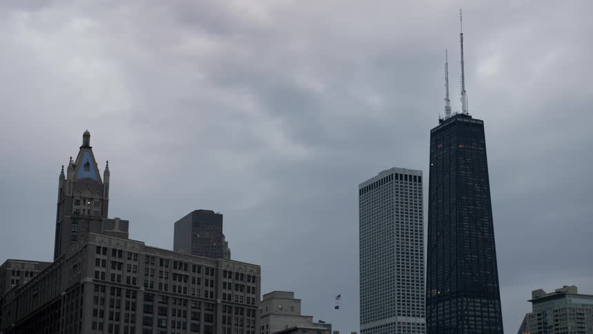 Clouds floating over city buildings