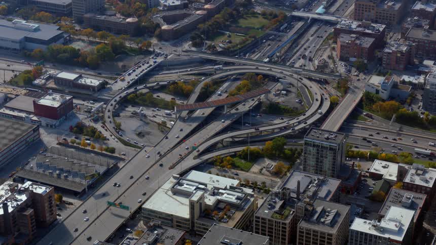 Time lapse view of traffic driving in a downtown city is displayed