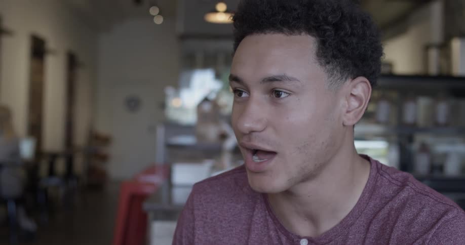 Man talks while sitting in a restaurant