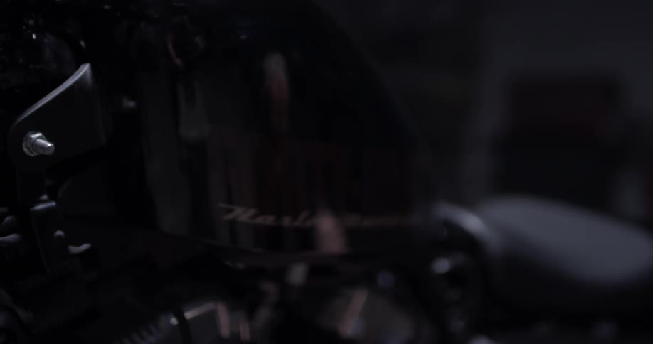Reflection in harley davidson of someone working on the motorcycle