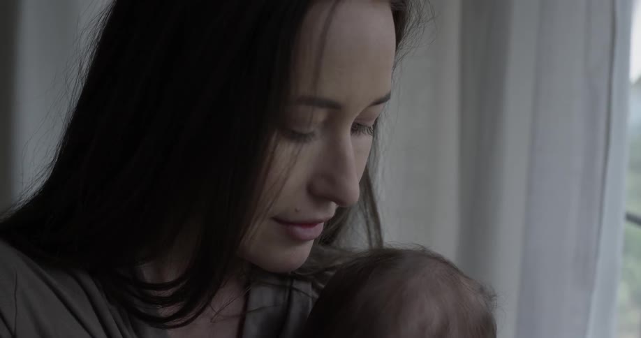 Woman holds baby a give it a hug