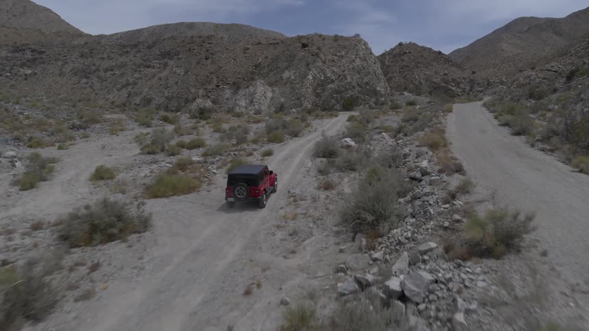 A car driving up a dirt road