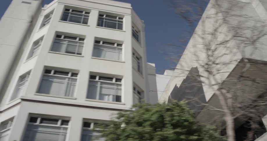 White buildings loom overhead