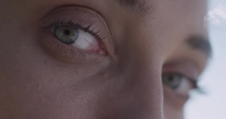 A woman stares directly at the camera