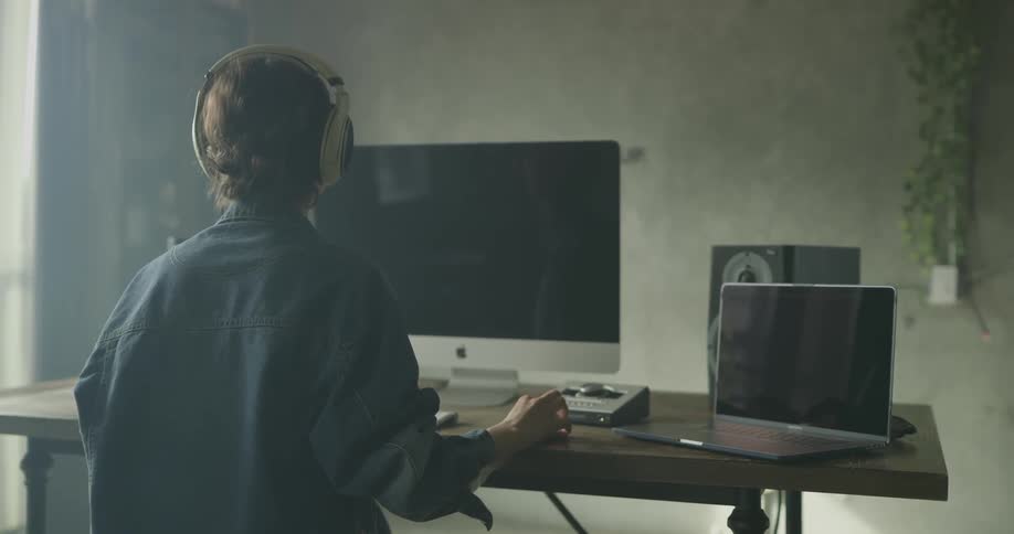 Woman Working On Computer In Studio