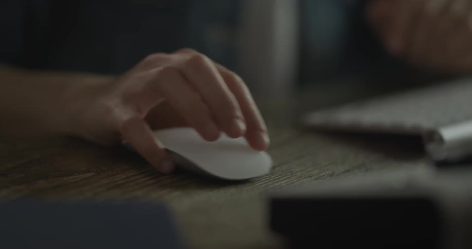 A person is moving a computer mouse