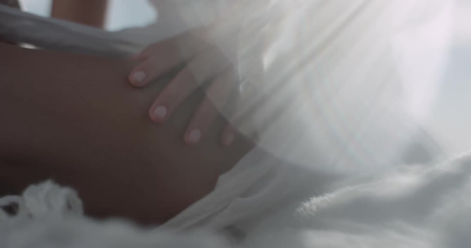 A woman is sitting down and touching her leg