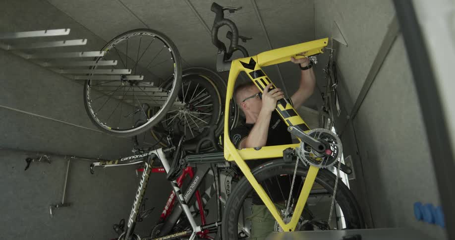 Man hooks up bike body to a wall