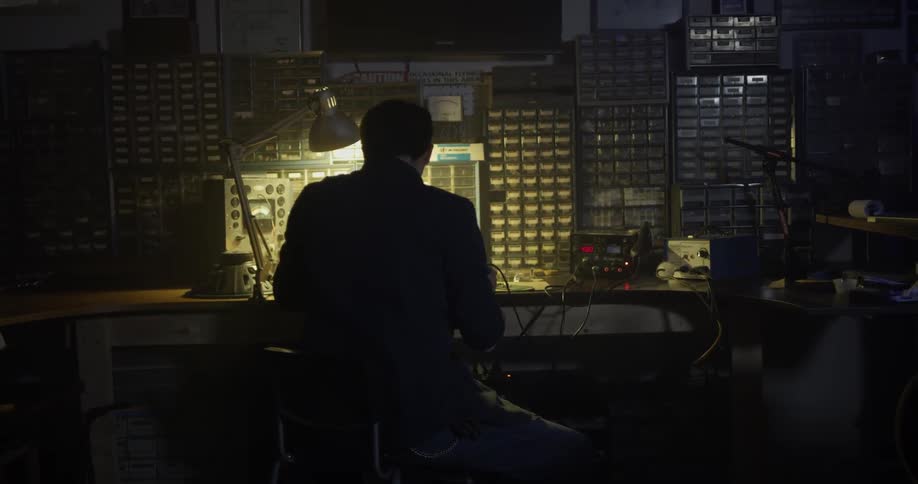 Man Soldering In Garage