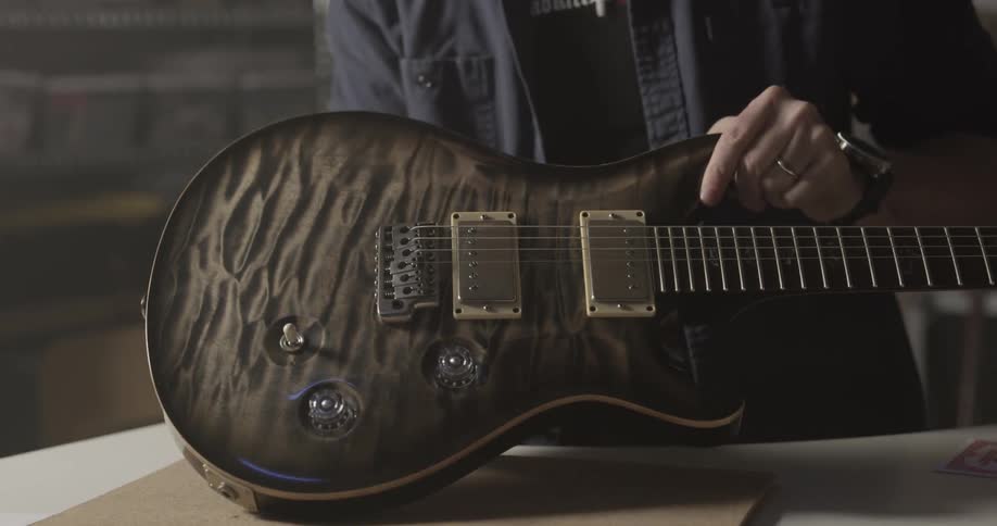 Someone is restringing a guitar