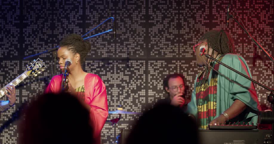 A musical group playing instruments on a stage