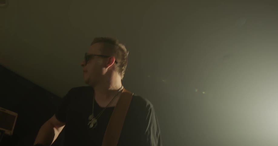 Man energetically plays guitar
