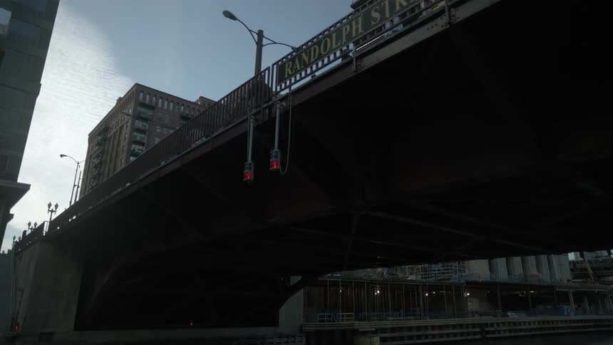 A footage of boat passing a river bridge