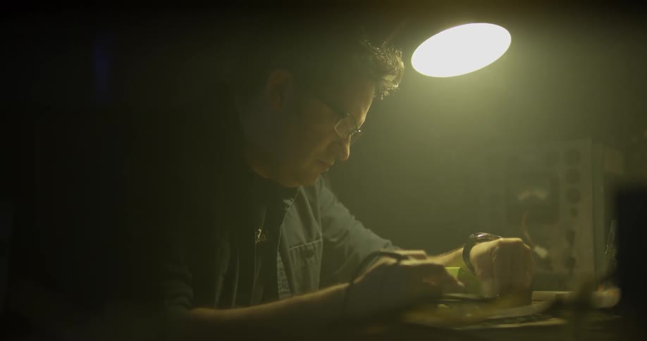 Man Soldering In Garage
