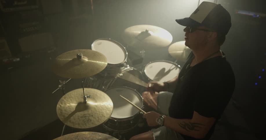 A man playing drums in a recording studio