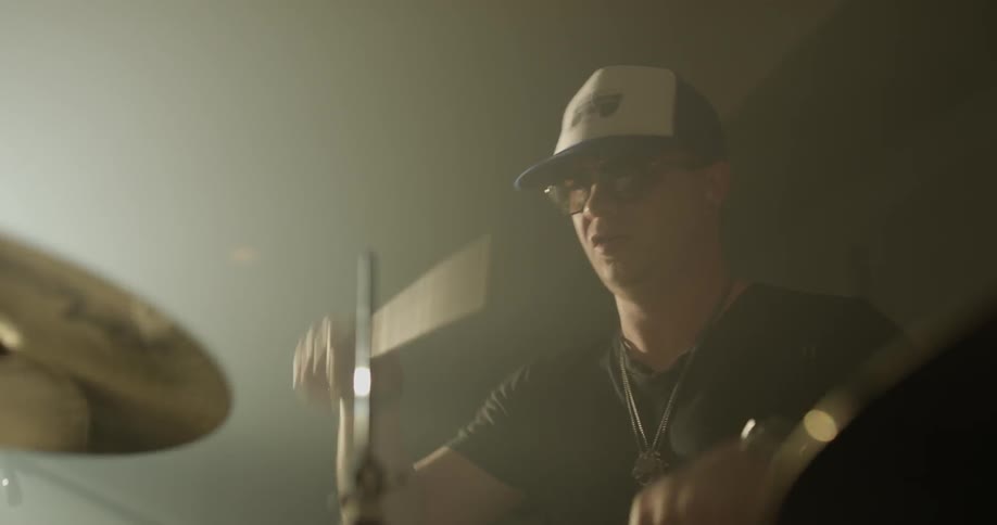 Caucasian male approximate age twenty  years old playing the drums
