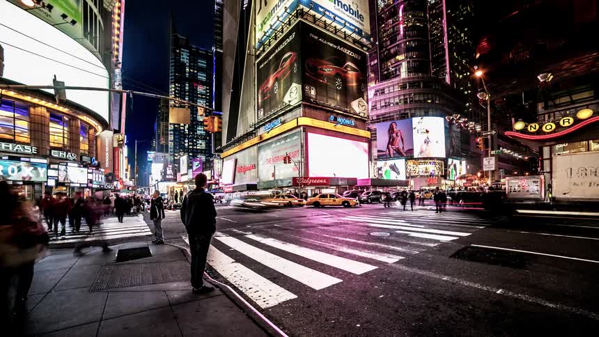 Time lapsed street scene of busy city square at night