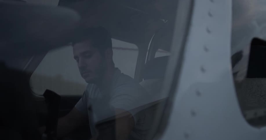 Man in cockpit presses buttons