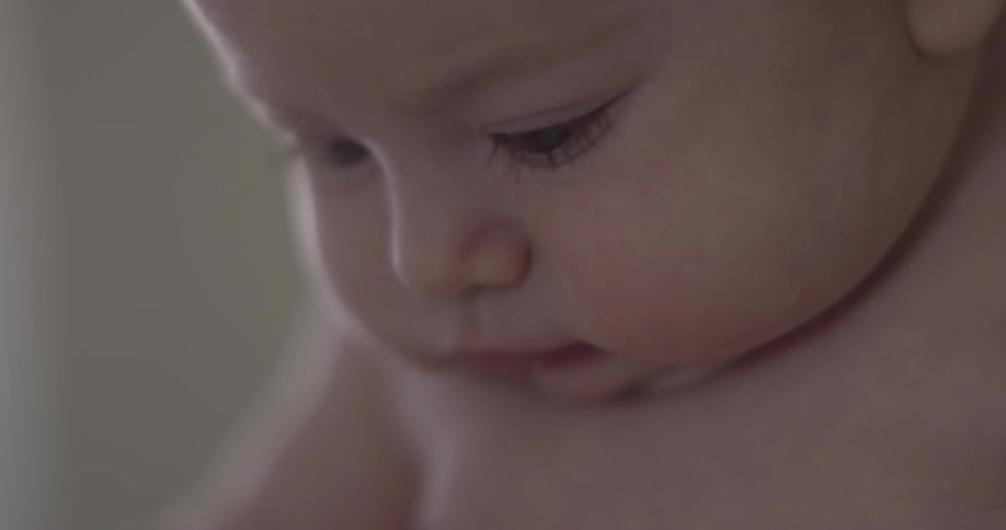 Baby looks down intently