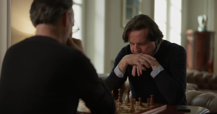 Two Men Playing Chess Inside House