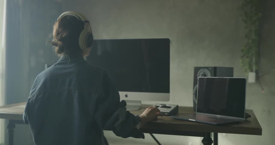A woman sits while working on her computer