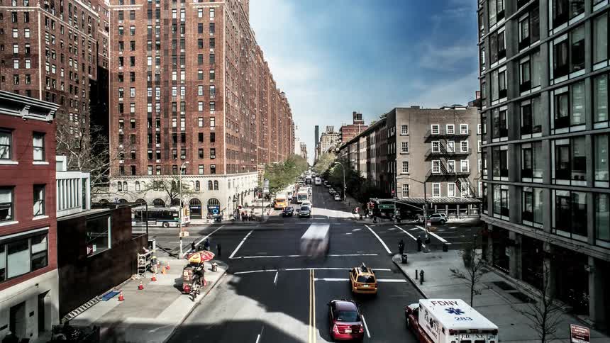 City street and sidewalk traffic flow through intersection in city