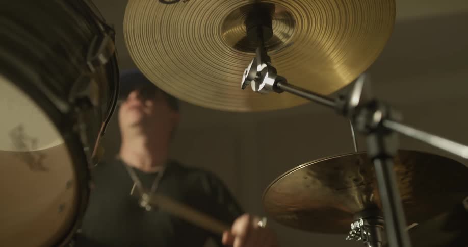 A man plays a drum set