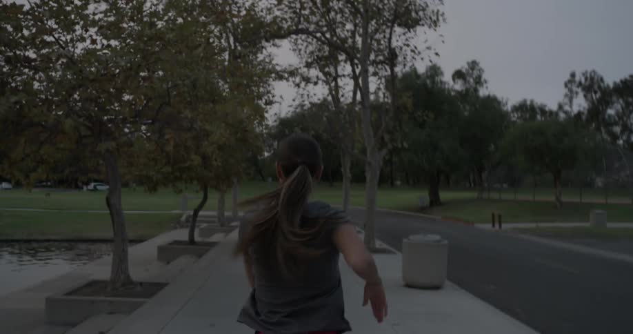 A woman stretches as she walks