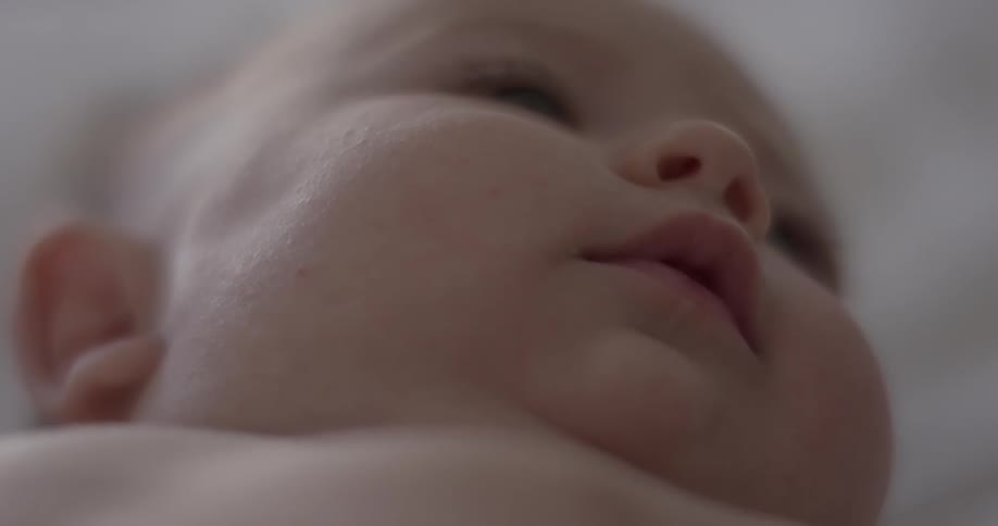 Baby on his back motionless for a few seconds and moves his throat and mouth
