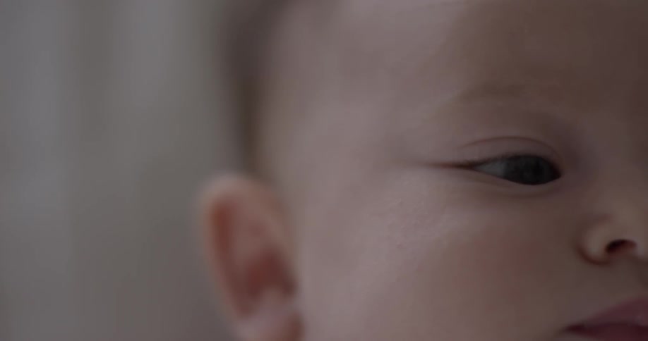 Half of baby's face while it looks ahead