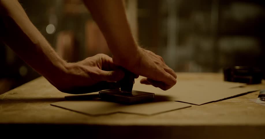 A person presses down on a stamp