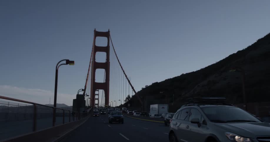 Multiple vehicles driving away from a bridge