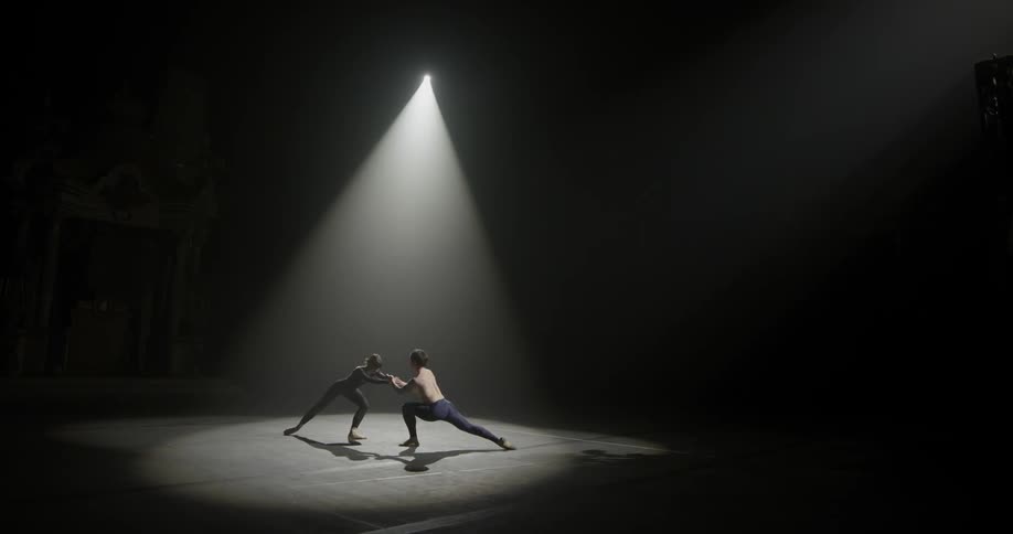 Two ballet dancers on a stage dancing