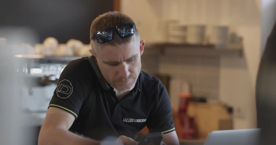 Man answers phone while using another phone