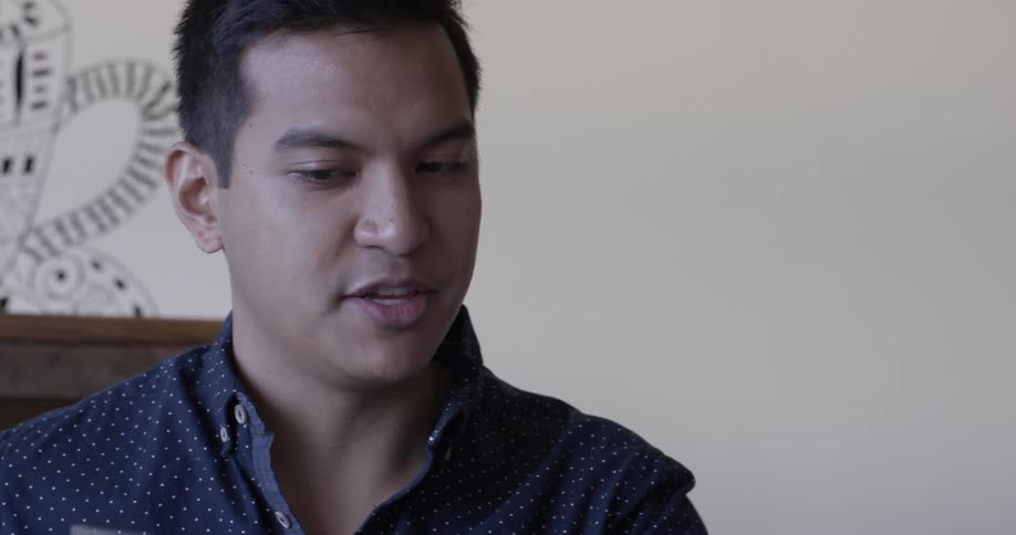 Man talks about content shown on laptop