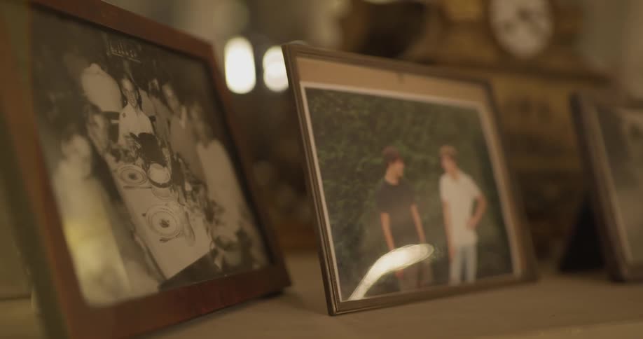 Family photographs are displayed on a mantle