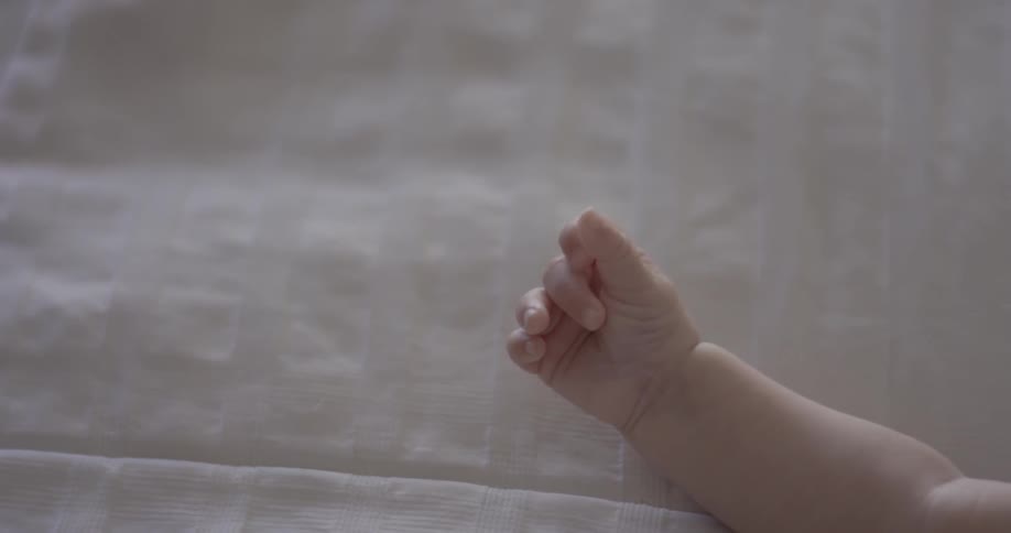 Baby closes and opens hand