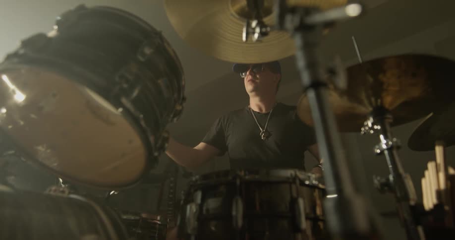 Man plays drums in
