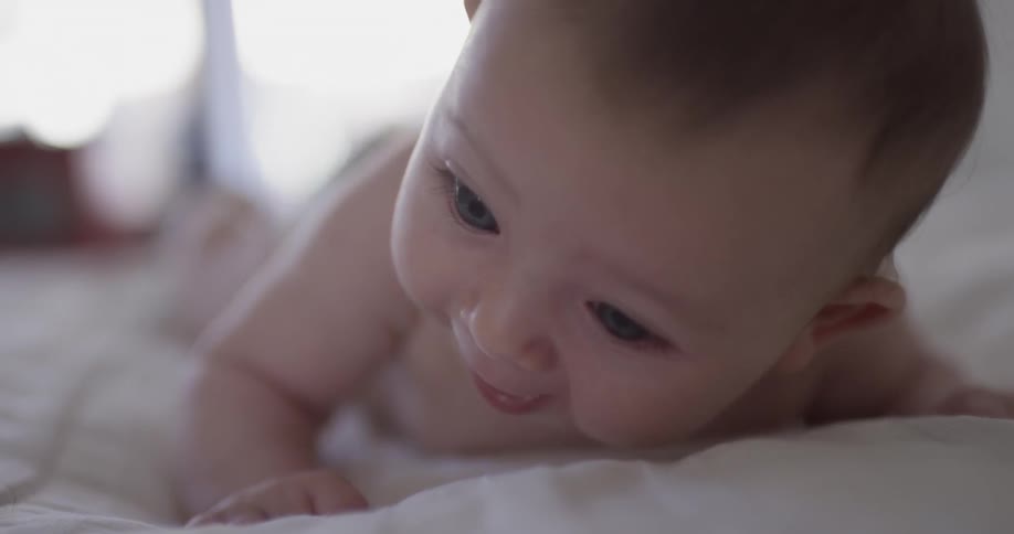 An infant laying on their stomach