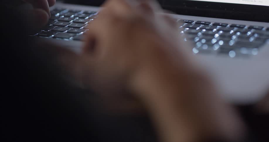 Person types on a laptop